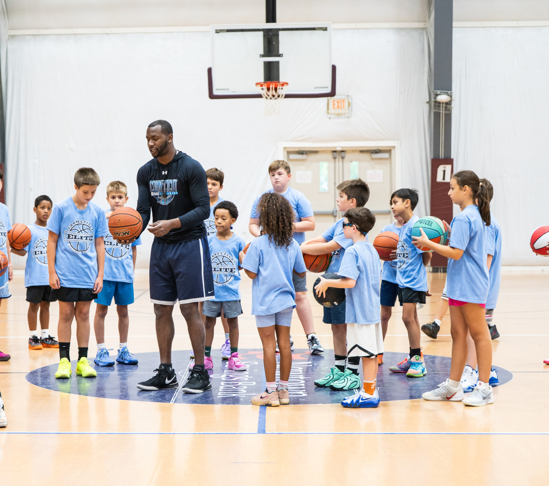 Connecticut Elite coach showing ball technique to a youth camp group