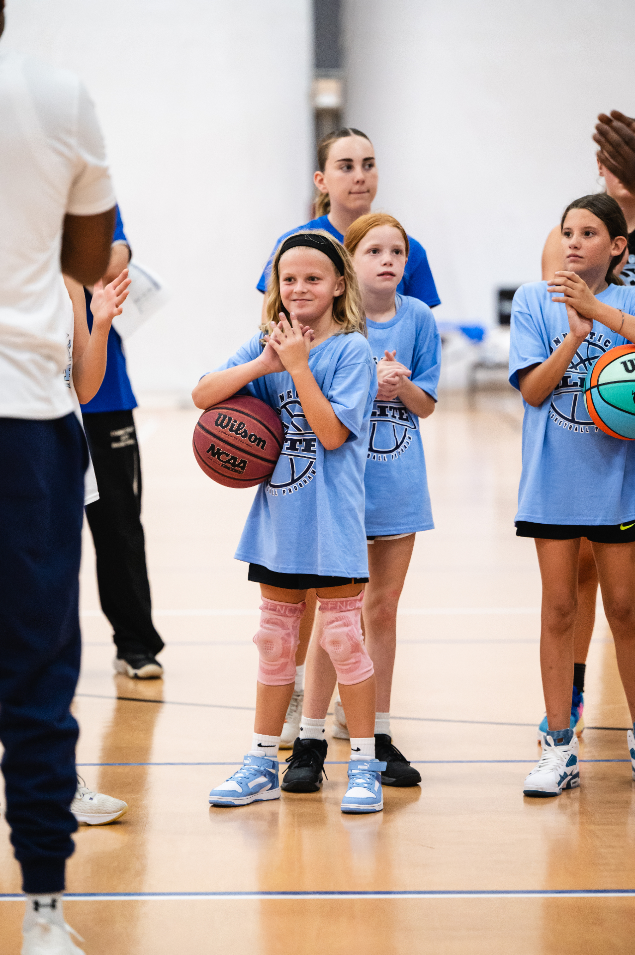 Young CT Elite players clapping during a coaching huddle